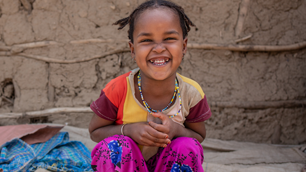 An Ethiopian girl smiles happily.