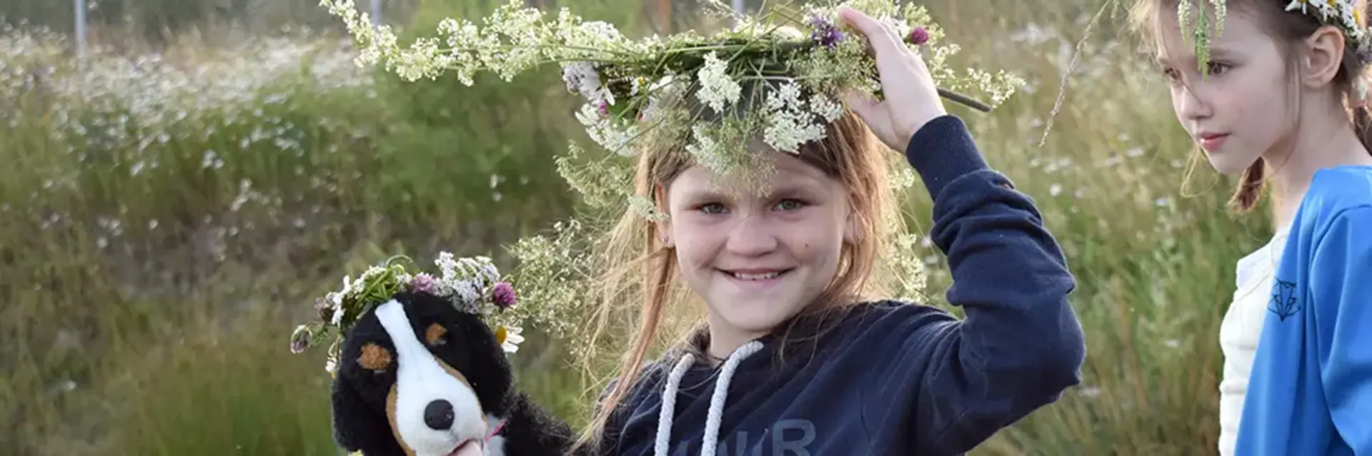A Ukrainian girl is wearing a wreath of flowers on her head.