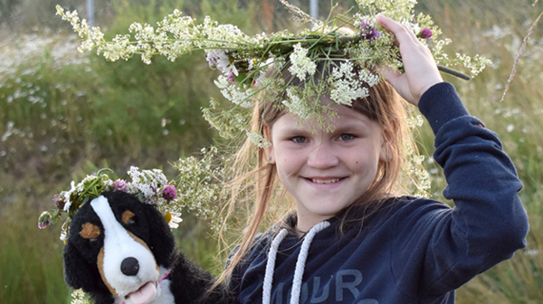 A Ukrainian girl is wearing a wreath of flowers on her head.