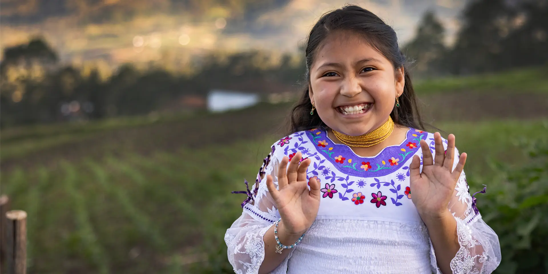 Herzlich Willkommen auf unserer Website. Ein Kind aus Bolivien winkt Ihnen auf dem Bild zu.